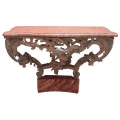 A painted wood console table with marble top