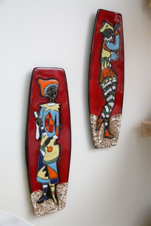 These whimsical, luminously glazed Italian ceramic plaques feature a pair of abstractly rendered court entertainers.