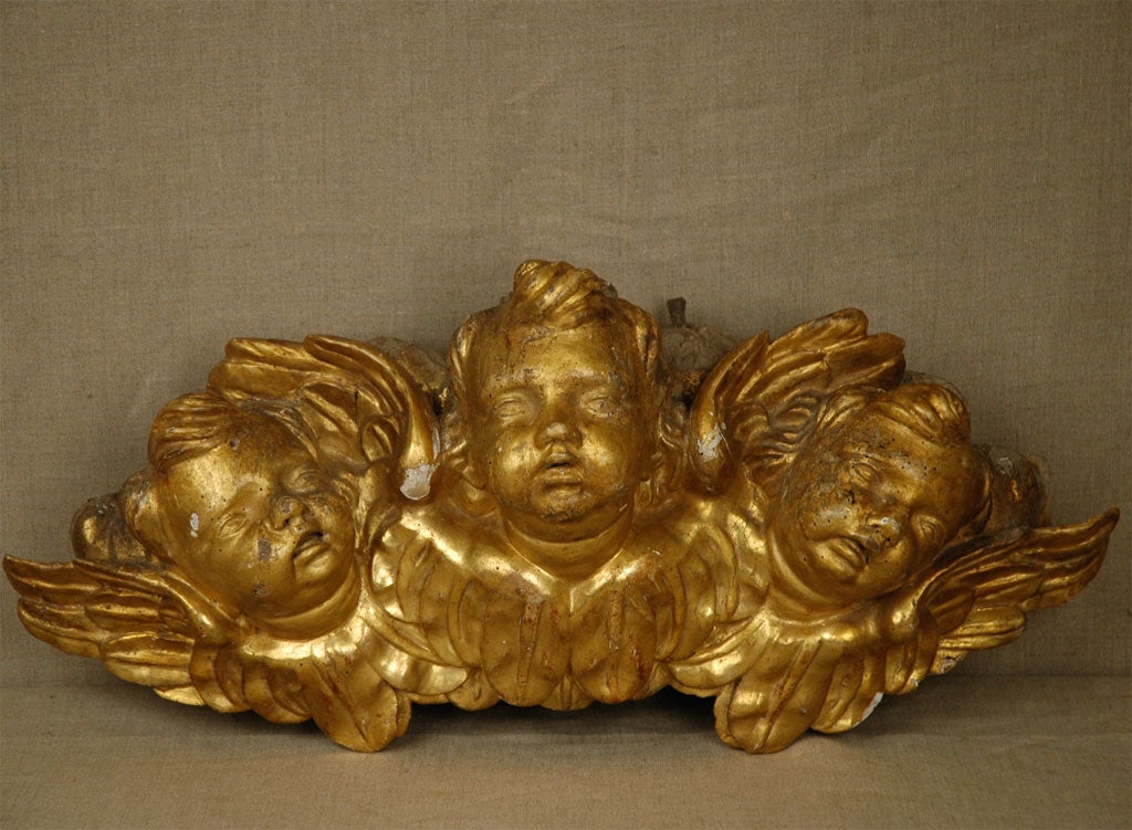 Carved, gold-gilded, wood trio of cherubim faces with wings. Most likely from an altar or much larger work of art.