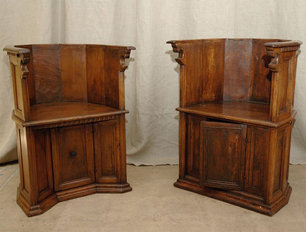 Pair of barrel back choir chairs from an Italian church. Made of walnut, each seat has a door below for a place to put a bible or books. These were generally used on the altar of a church.