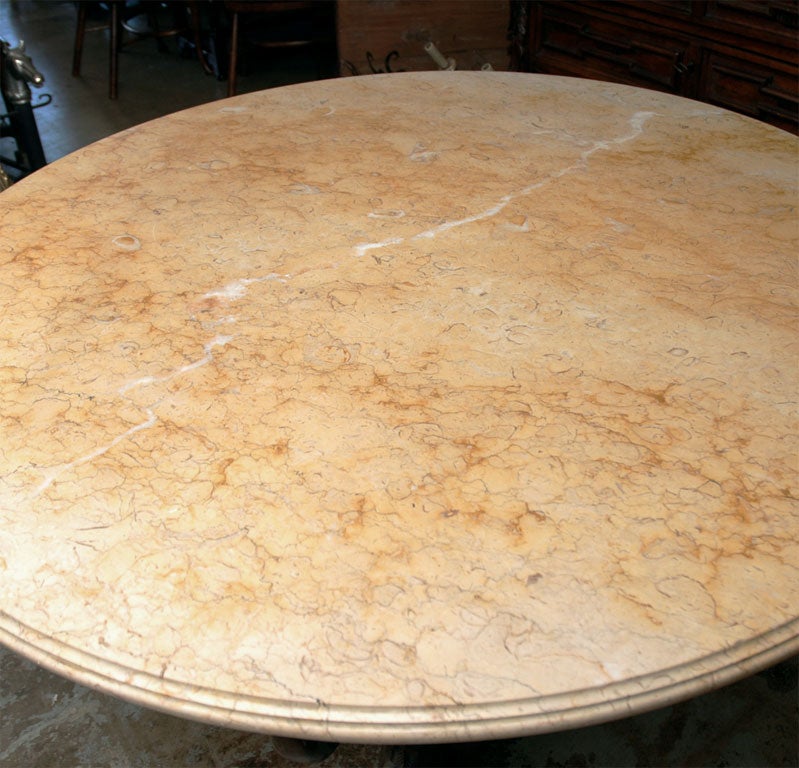 Hand-carved, center-table from Naples. Base features three stylized dolphin supports surmounted by a Siena marble top.  