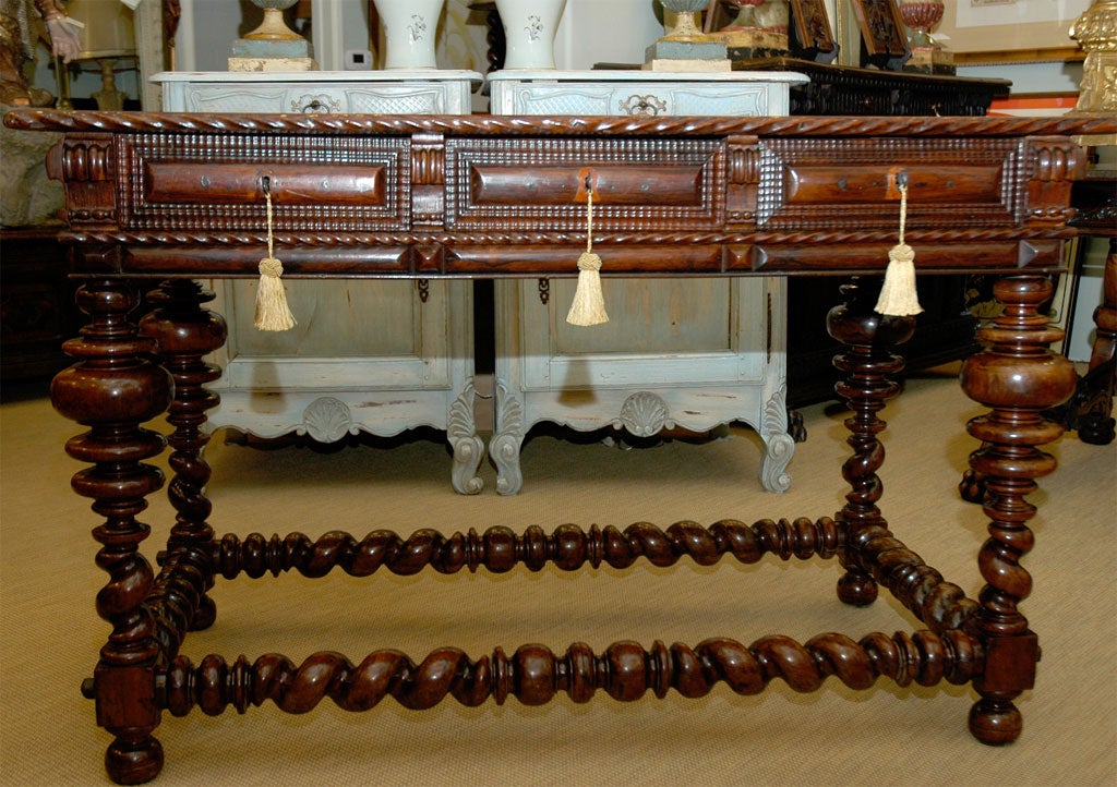 18th Century Portuguese Rosewood Table with three drawers and original hardware. Elaborately turned bobbin legs and twisted stretchers.