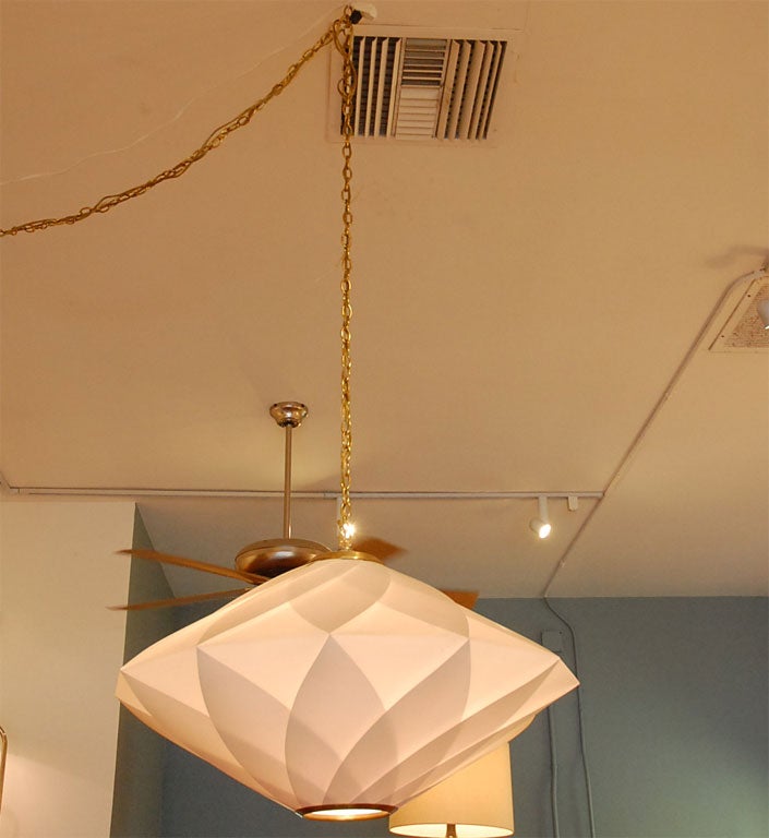 Striking large lighting fixture from the 1960’s.  Hard plastic sheets overlap each other making a graphic diamond design.  The cream plastic is accented with gold trim and chain.