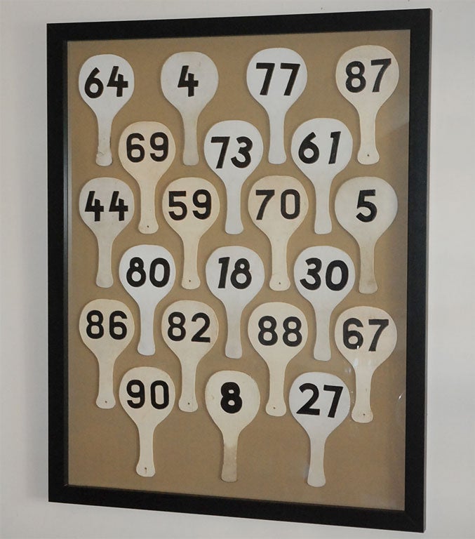Canadian auction paddles from the 1960’s have been mounted on beige linen and framed in black.