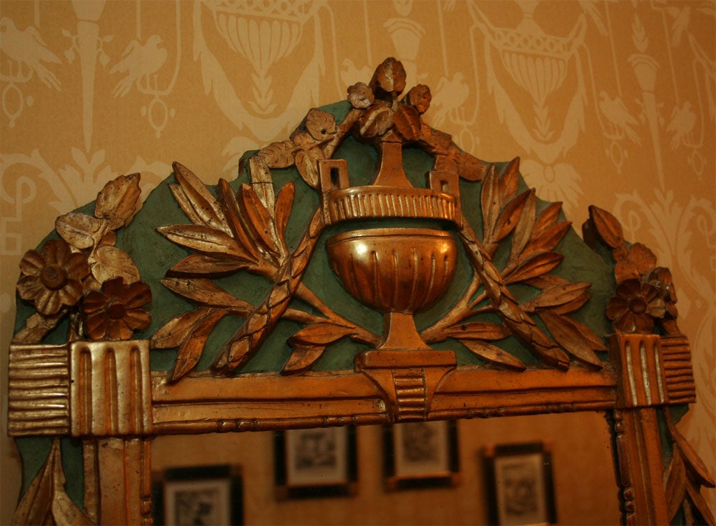 A charming Louis XVI period giltwood and polychrome Provençal mirror, with lovely carving of an urn, flowers and olive leaves on pediment, inner beaded molding and mercury glass.