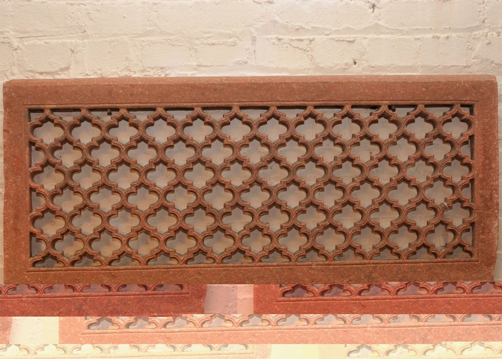 Classic pierced, red sandstone screen, or jali, from the Mughal period, featuring interconnected medallions. Screens such as this were widely used as windows and room dividers, especially in women's quarters. Nearly identical pair.