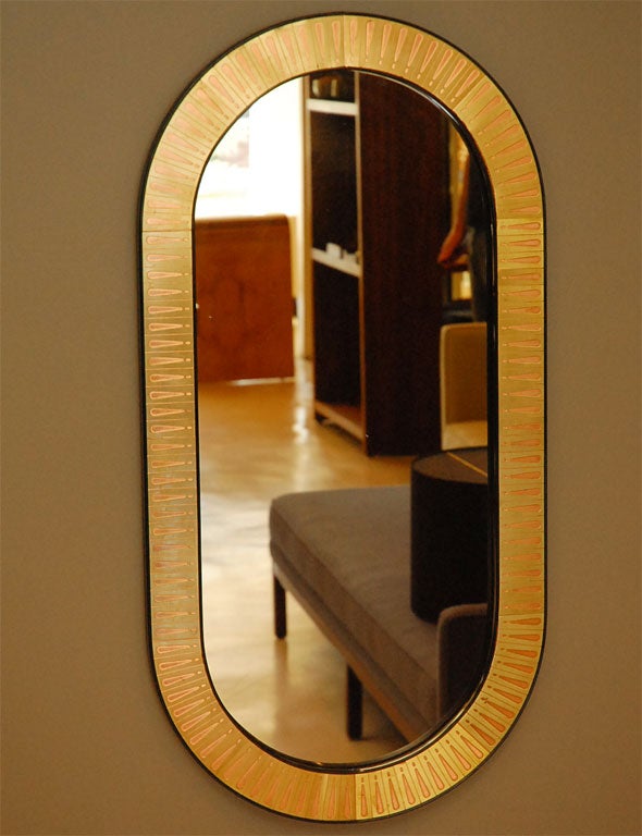 Oval brass and copper Bijan Bijan mirror.  Artist Bio on back.