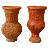 Unmatched pair of large scale artisinal terracotta urns.