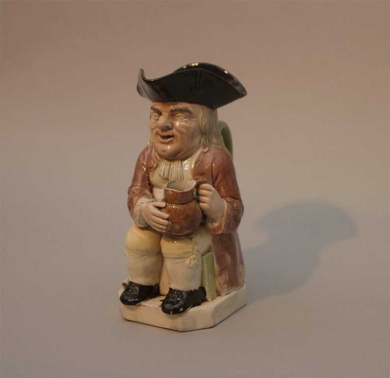 a fine English pottery toby jug attributed to Ralph Wood, decorated in translucent colors of light and dark brown,green and yellow