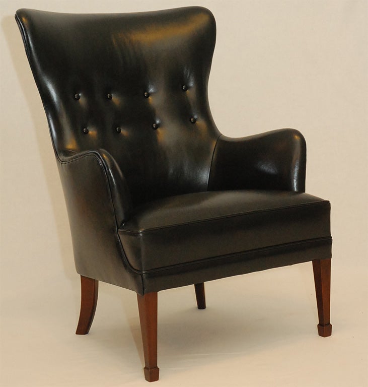 Frits Henningsen black leather armchair.  Store formerly known as ARTFUL DODGER INC