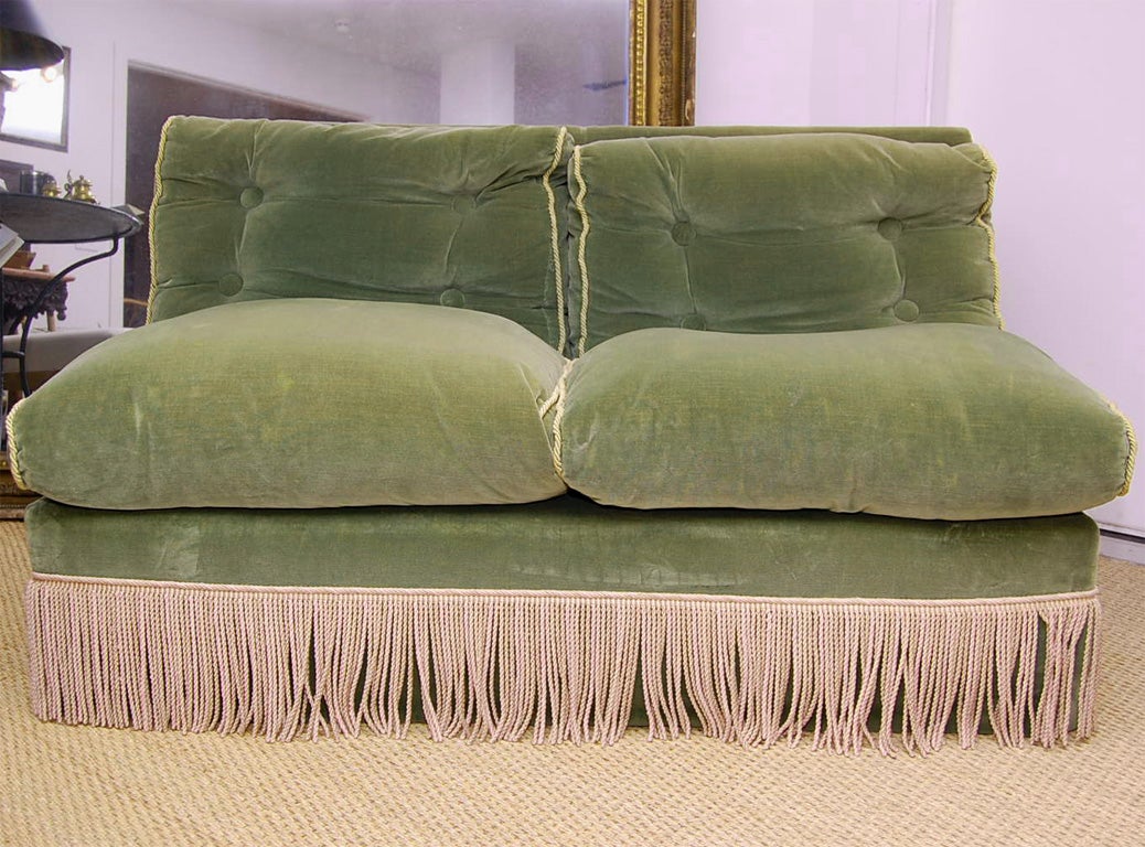 A two-seat banquette re-upholstered in moss green velvet with matching piping and lavender rope fringe.<br />
CONTACT US FOR<br />
SPECIAL DEALER PRICE.