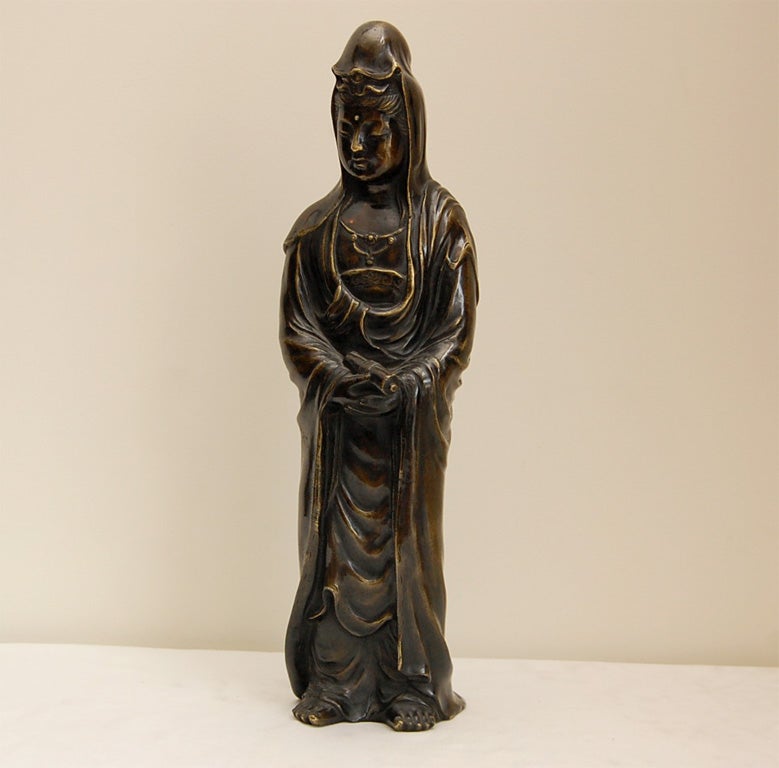 Kannon, holding a Sutra, is the Bodhisattva of Mercy and Compassion. She is often depicted as floating in the clouds and is a beloved deity in both Japan and China. A Bodhisattva is an enlightened being who follows the teachings of the Buddha, and