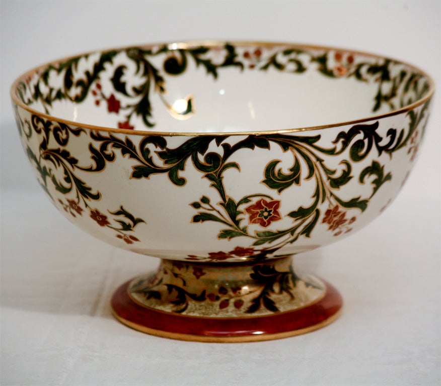 Douton Burslem footed punchbowl with unusual Arts and Crafts decoration. Highly decorated foot with gold tracery and wonderful combination of colors. This would look lovely on a center table, used as a centerpiece or filled with delicious food for a
