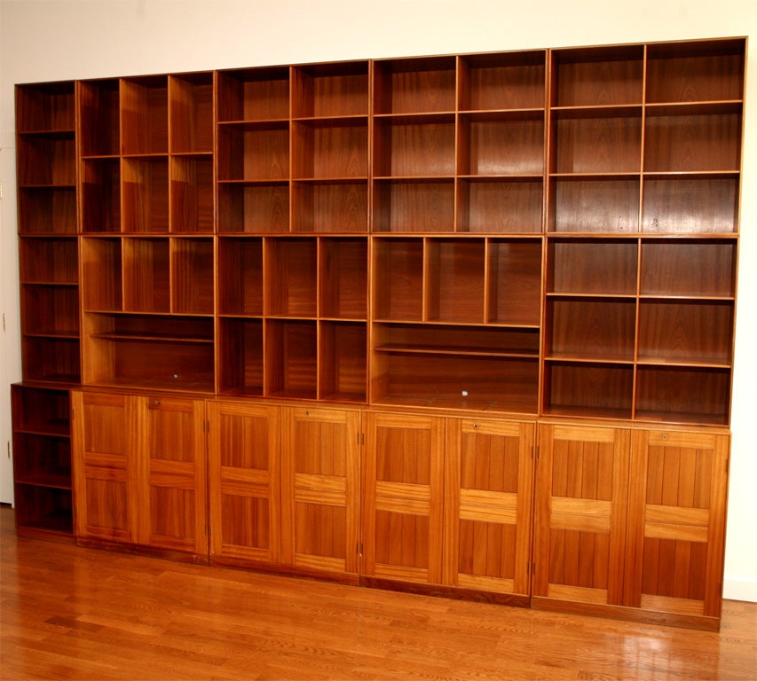 Designed by Mogens Koch in the 1930's and produced by Rudolf Rasmussen in 1962. Made of Cuban mahogany with dovetail joinery. Features reconfigurable elements - a cabinet base with locking doors and upper bookshelf elements which can be rotated to