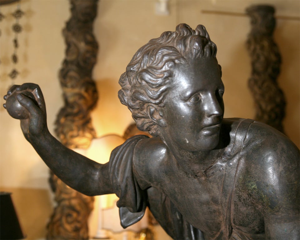 This very nice three quarter life size cast iron statue of Hippomenes would make a definate statment in any home or garden. The figure cast as a youth in classic short tunic is throwing pure gold apples to distract Atalanta against whom he was