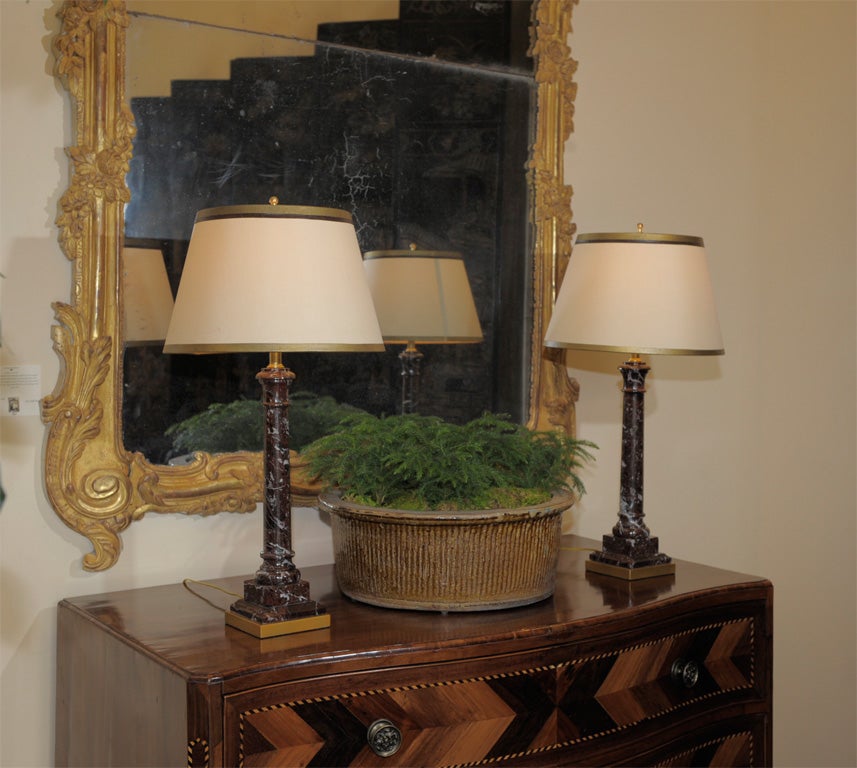 Pair of early 20th century Classic form breche d'alp marble antico columnar lamps on stepped marble and gold leafed bases. Custom silk trimmed shade, circa 1920.