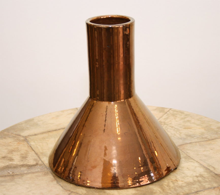 Trumpet form with metallic copper glaze.