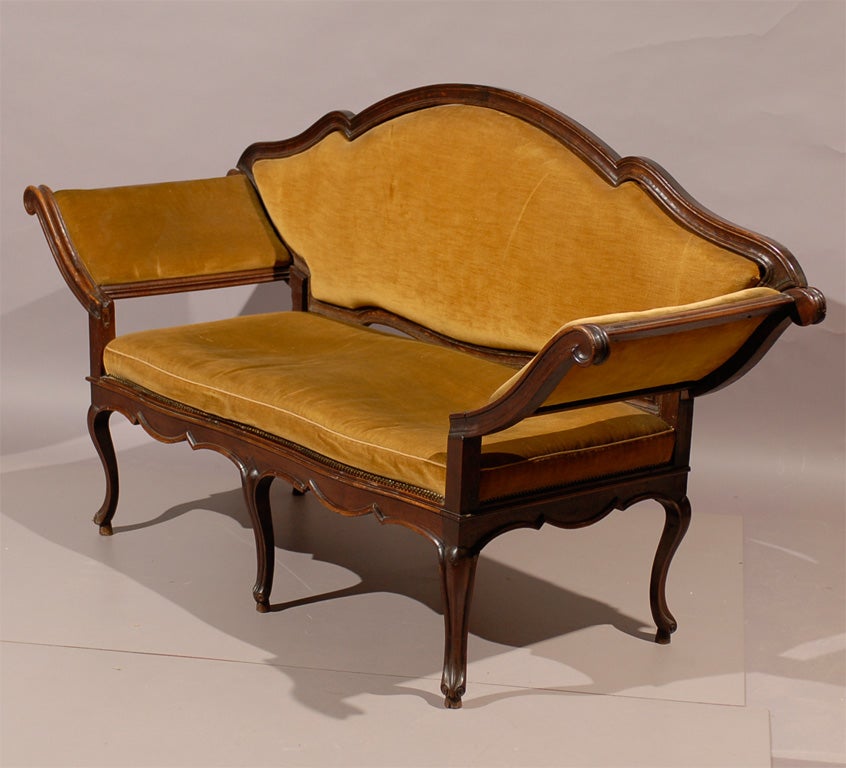 An 18th century rococo Venetian walnut settee with splayed out arms and removable back.

William Word Fine Antiques: Atlanta's source for antique interiors since 1956.