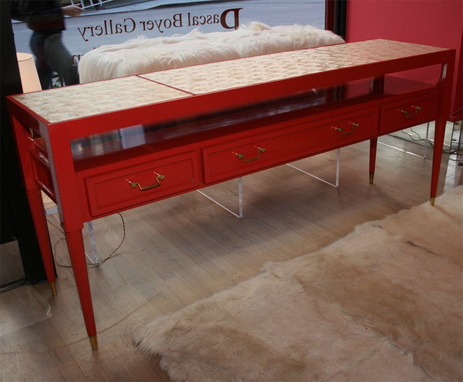 Fantastic console by Tony Duquette done in coral lacquer with a natural Capiz shell tops.