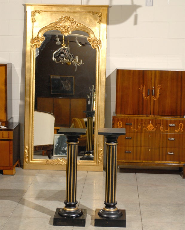 Pair of antique Empire Neoclassical Swedish pedestals painted ebony with gold accents.