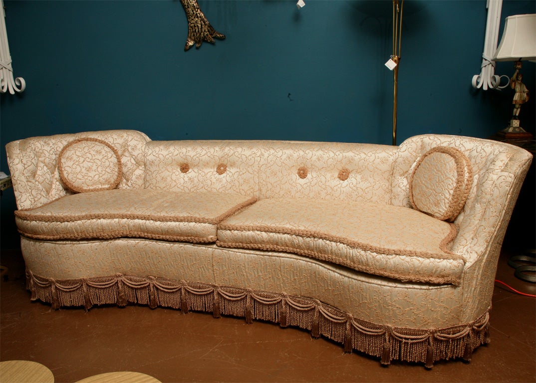 Sexy Hollywood Regency wrap around sofa. In original tufted and fringed fabric.