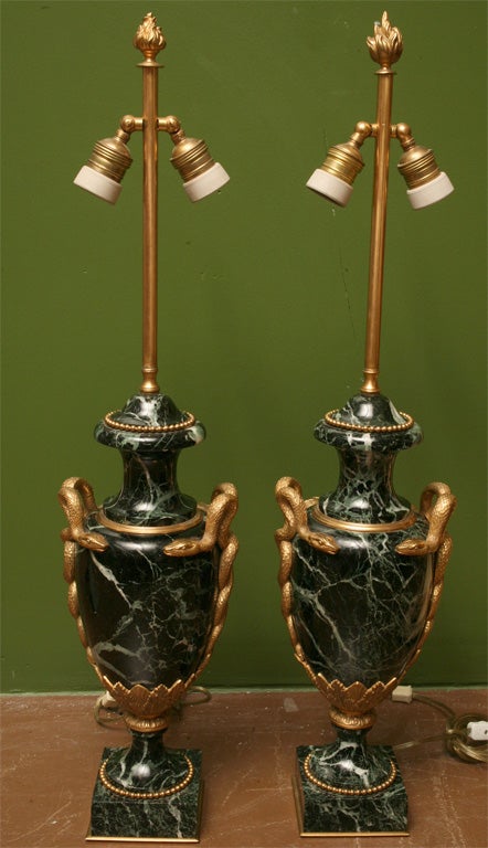 Pair of elegant marble and bronze urn lamps with snake motif.