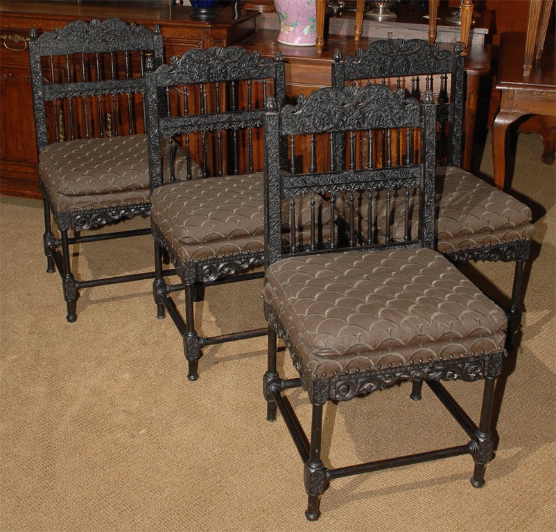 A RARE SET OF FOUR ANGLO-INDIAN CARVED EBONY CHAIRS MADE IN INDIA DURING THE FIRST PART OF THE 19TH CENTURY.  WE HAVE PRICED THE CHAIRS AS PAIRS.