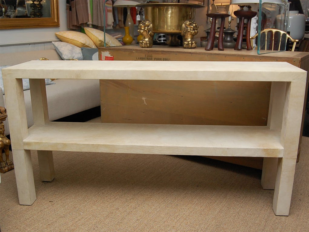 Parchment covered parson's style console with second shelf