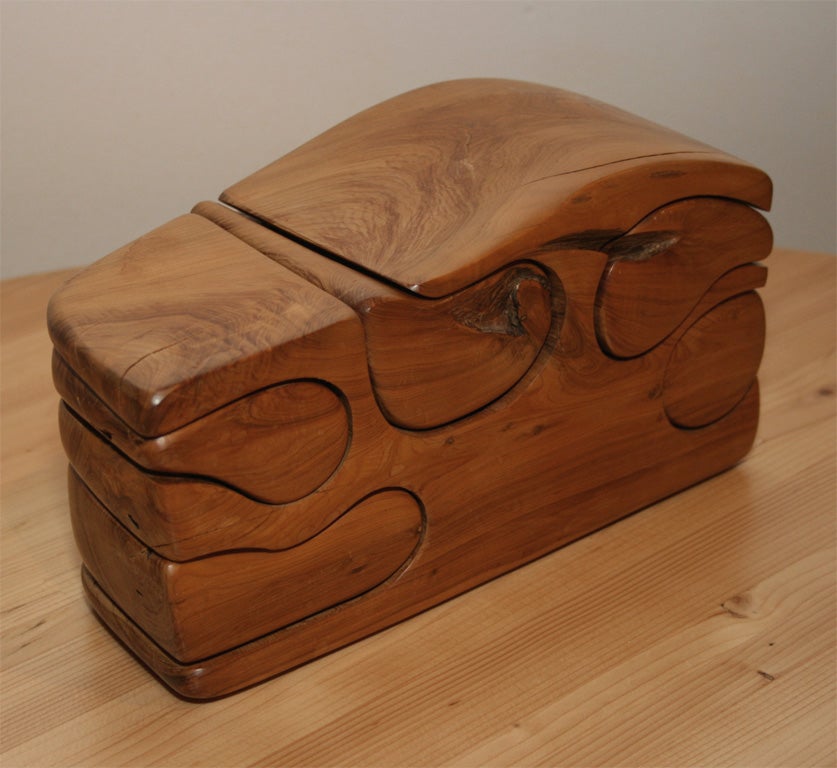 Wooden puzzle box, probably from the New England area, created c. 1970.  Five<br />
small drawers.  Artist cypher on bottom.