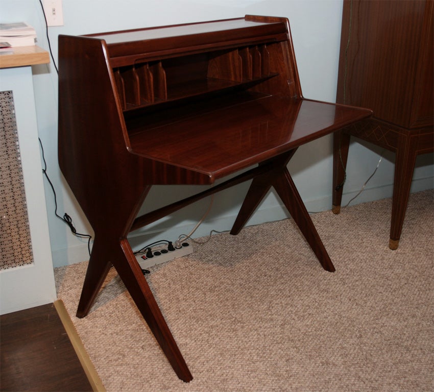 Petite desk in mahogany, with tamboor drop front, concealing storage compartments.  Lift-up writing panel conceals more storage as well.  Elegant form and functional design.  *This desk is featured in an ad for Borsani in Domus Magazine, June, 1954.