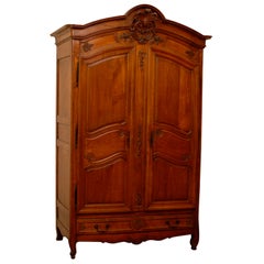 Antique French Louis XV Style, 19th Century Carved Cherrywood Armoire with Four Drawers