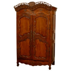 French Late 18th Century Cherry Armoire from Rennes with Hand Carved Décor