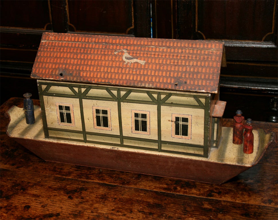 A mid-19th century German Noah's ark model with over 50 hand-carved animals, all retaining their original paint, the ark with painted tiles, windows and wall timbers and, on the roof, a painted dove holding an olive branch in its mouth.  Top of ark