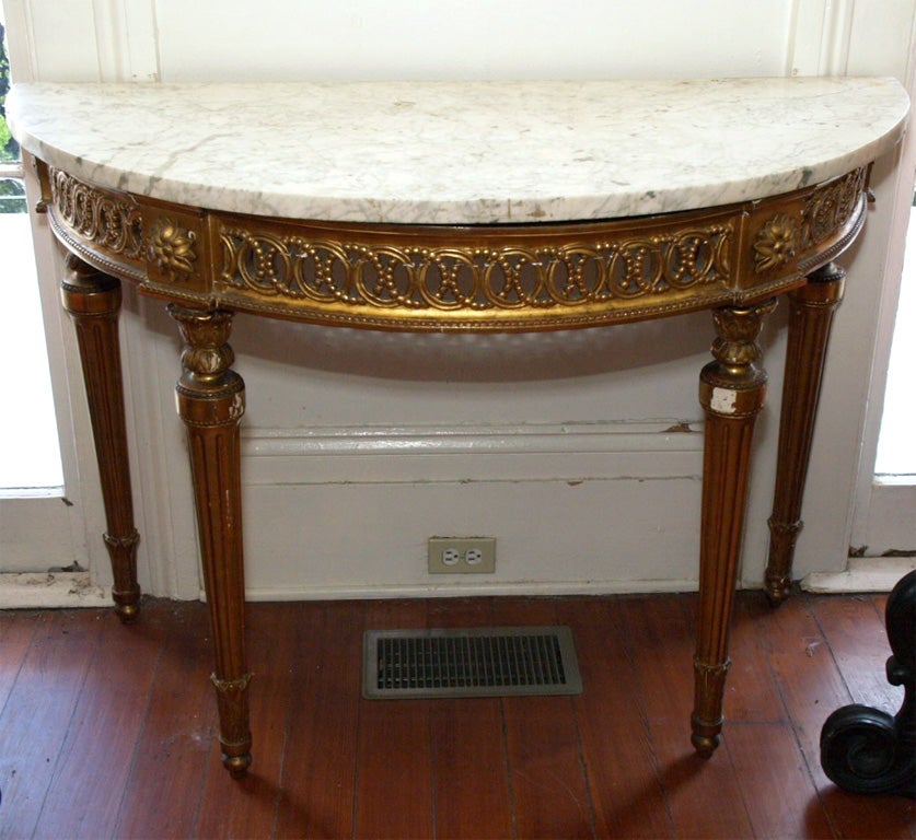 Period Louis XVI Giltwood console with marble top and pierced apron. Exceptional. Small gilt losses to left leg.