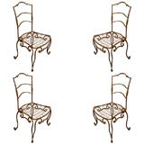 Set of four Jean-Charles Moreux gilt metal chairs