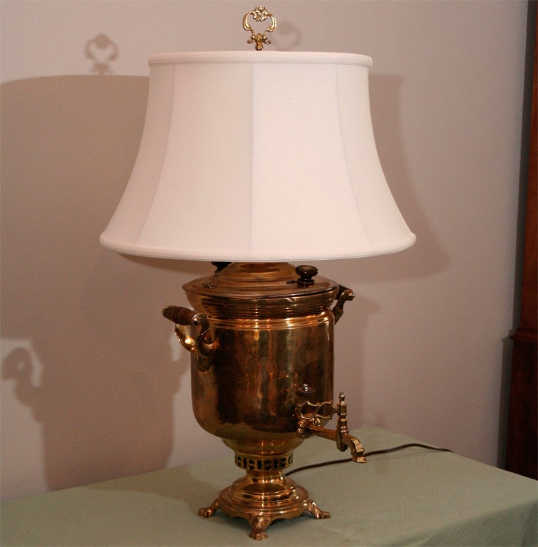 Brass Samovar lamp was converted to electrical sometime in the 1980s. While piece has been polished extensively over the years, an impress of an original Russian crest appears over the spigot.