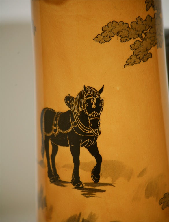 Impressively tall Arts and Crafts amber-yellow cider pitcher with striking black contrasted work horses, decorated all around the body.