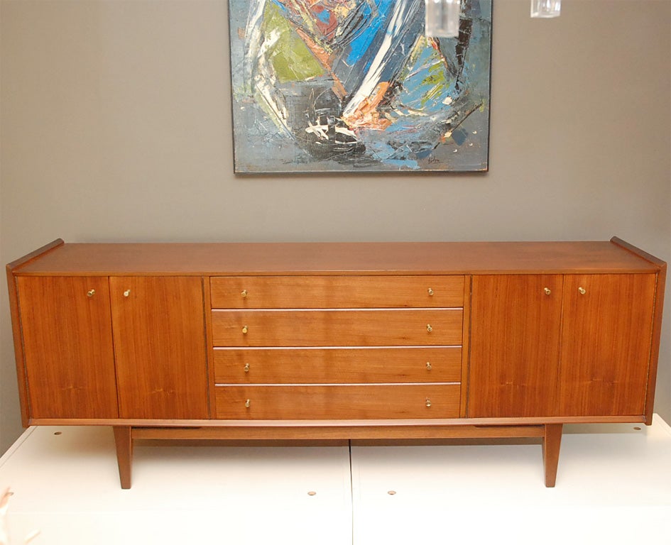 Beautiful and classic mid-century British sideboard with brass hardware reminiscent of Paul McCobb.