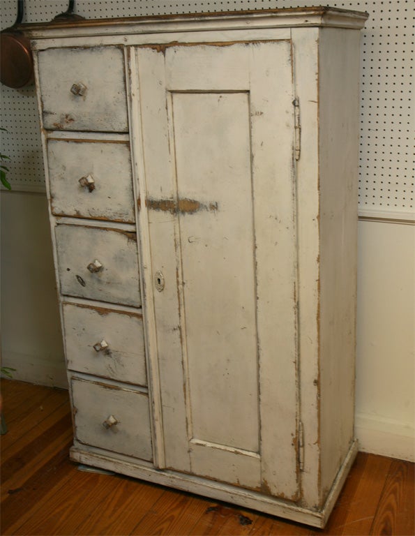 A dandy of a pie safe is this one!! It has a stack of five chubby drawers on the left, each having the most interesting diamond shape wood pull. The large paneled door to the right opens to four large storage areas. It is great looking and very