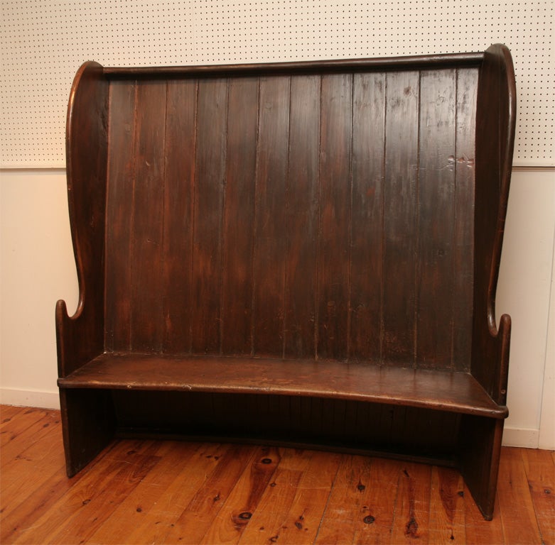This English pine settle was used in a pub, int the Yorkshire area of the United Kingdom. It is curved on the back and finished on all sides.Its most recent home was the center piece of the Berkshires most well know restaurant,