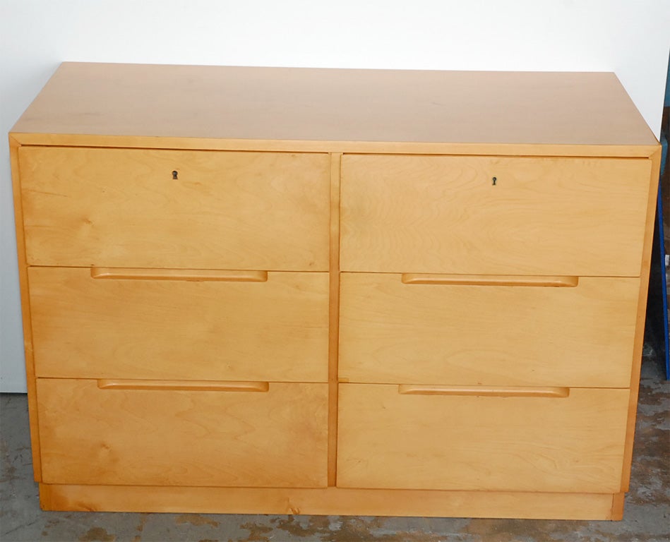 A beautifully detailed and practical birch dresser by the great pioneer, Alvar Aalto. The straightforwardness of this piece reflects the unpretentious humanism of its designer. The top two drawers are lockable, for those with expensive taste in