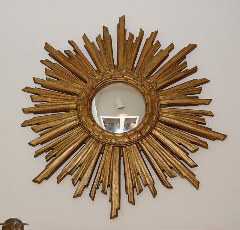 A 1920's Sunburst Mirror made of Giltwood with a round convex mercury mirror.