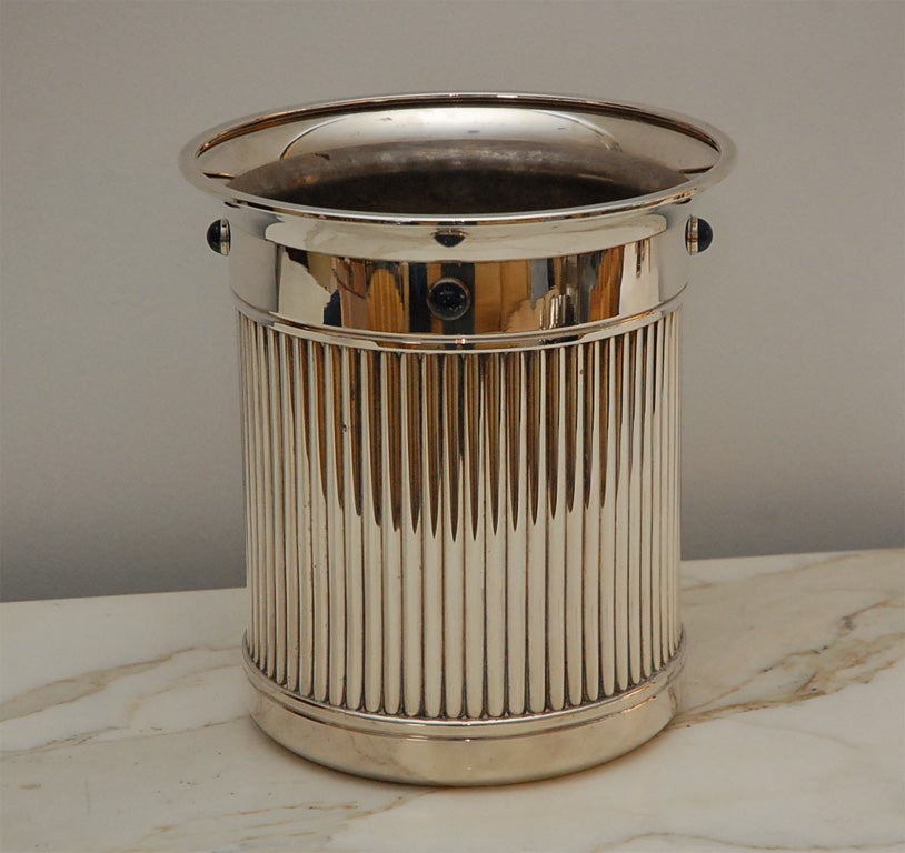 Beautiful fluted bucket for the perfect bottle of champagne!  Excellent quality silver plate finished with studs of Lapis Lazuli.  This bucket retains it original aluminum liner.  Signed with a script Cartier signature.