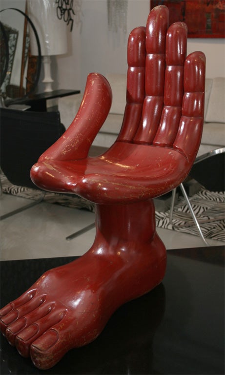 Wooden red painted chair that symbolizes an era. A great piece of furniture and art.

Signed on thumb and wood burned signature on bottom of foot.