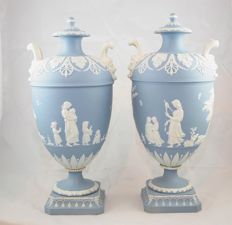 A rare pair of Wedgwood blue and white jasper two handled covered vases decorated in relief with 