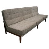 Florence Knoll armless 3 seat quilted sofa with walnut base