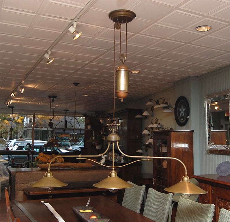 Handmade, Italian brass light fixture with counterweighted pulley system.  Takes 3 100w standard bulbs.  Design exclusive to Coutnry Gear Ltd.