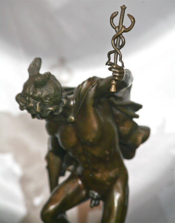 A BRONZE SCULPTURE OF MERCURY, ON MARBLE BASE, SIGNED BY 