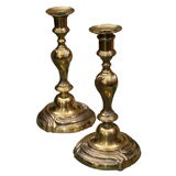 A pair of French Louis XV silvered candle sticks