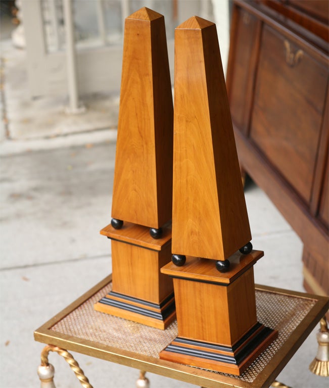 A very nicely scaled and constructed pair of olive wood obelisks. The woods chosen to complete this pair are very figured and beautifully colored. Lastly the ebonized details give a manly and timeless element to the pair.